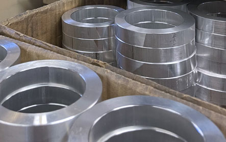 Stacks of CNC milled metal rings that are ready for shipping