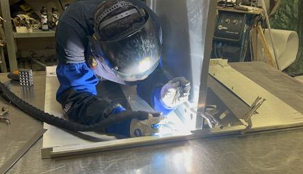 New Com welding technician assebling a NEMA control enclosure