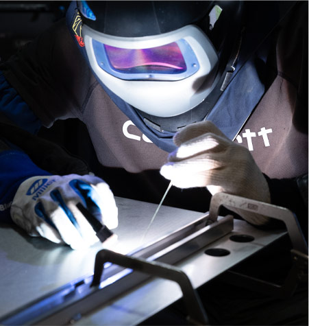 A technician welding an assembly at our Randolph facility